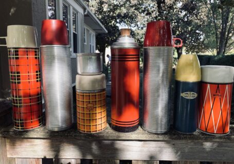 My husband Shawn's vintage thermos collection in our backyard